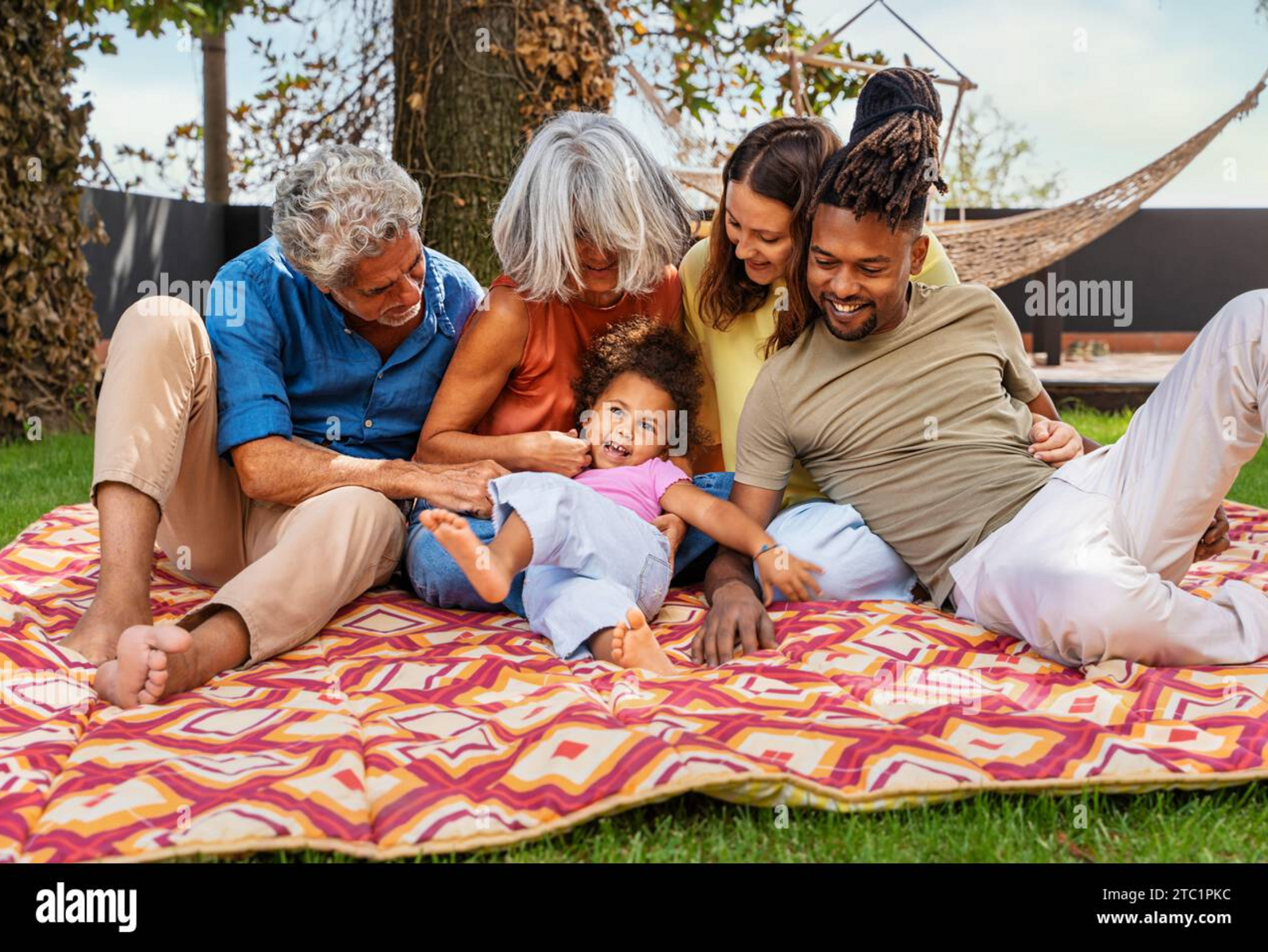 Multigenerational multicultural family laughing together